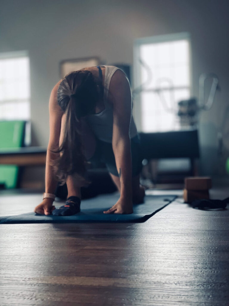 picture of a women stretching on a yoga mat